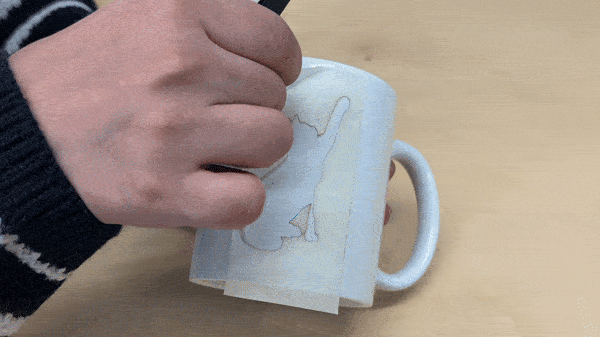 Placing a stencil on the mug